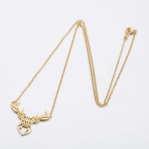 Detailed macro view of a gold-plated stainless steel reindeer antler pendant necklace