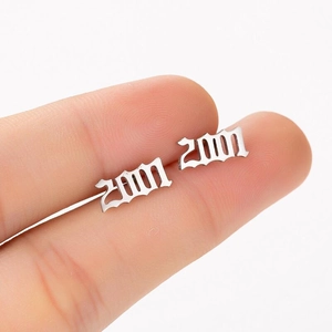 Close-up of silver Gothic 2000 year stud earring held by hand to show compact size