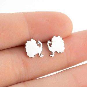 Close-up of minimalist peacock silhouette stud earrings in polished silver stainless steel