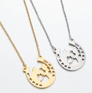 Detailed view of hollow horseshoe pendants with knight silhouette in gold and silver