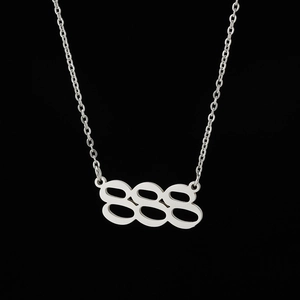 Macro view of silver stainless steel 888 angel number pendant with fine chain