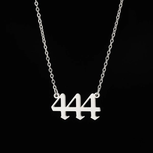 Macro view of silver gothic 444 angel number pendant necklace in stainless steel