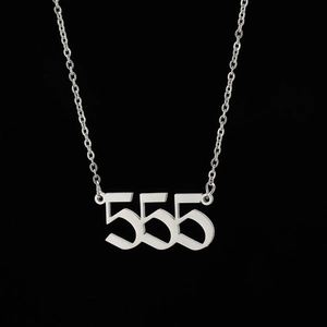 Detail of silver stainless steel pendant featuring number 555 on a minimalist chain