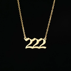 Detailed close-up of gold 222 angel number pendant on a fine stainless steel chain