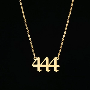Detailed close-up of golden number 444 pendant with polished stainless steel finish