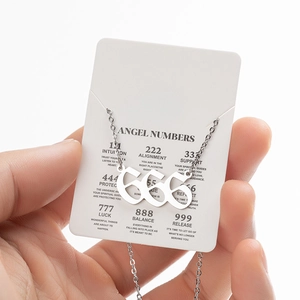 Silver angel number 666 pendant necklace with spiritual meaning card in macro view