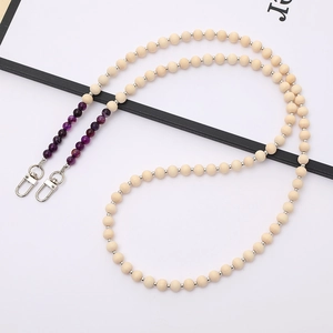 Detail view of wooden beads and purple agate stone on a multi-purpose crossbody chain