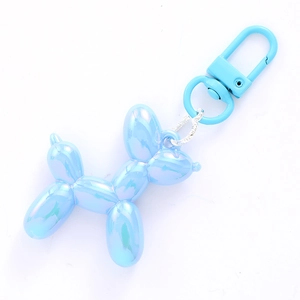 Blue pearlescent acrylic balloon dog keychain with silver metal lobster clasp on white background