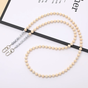 Detail of beige wooden beads and marble textured accents with silver lobster clasps