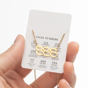 Detail of gold angel number 888 necklace with symbolic meaning description card