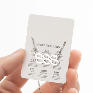 Silver stainless steel 888 angel number pendant necklace held on descriptive card