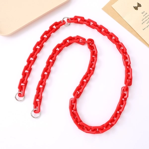 Close-up of bright red acrylic link chain with silver metal clasps for bags or phones