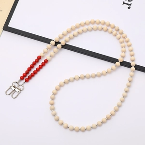 Detail view of wood and marble-textured beads on strap with silver lobster clasps