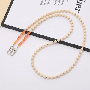 Detail of beaded wooden strap with orange accent beads and silver metal lobster clasps