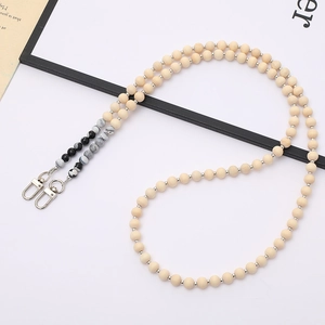 Close-up of wooden bead chain with marble accents and dual silver lobster clasps