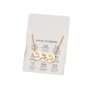 Unisex gold stainless steel angel number 999 pendant necklace on meaning card