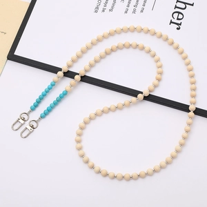 Crossbody phone strap with beige wooden beads, turquoise stone accents, and metal clasps