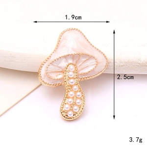 Detail of mushroom charm with pink enamel, pearls and dimensions 1.9cm by 2.5cm