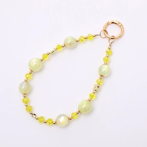 Iridescent mermaid pearl phone strap with yellow crystal beads and gold butterfly pendant