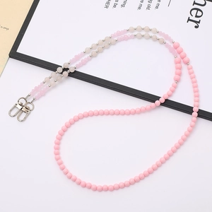 Handmade pink and cream beaded phone strap with silver lobster clasps on white background