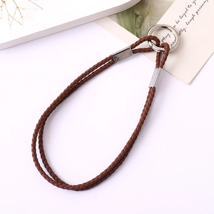 Close-up of dark brown woven leather phone strap with silver metallic ring and clasp