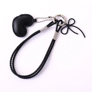 Minimalist black woven leather heart keychain with bow pendant and silver ring clasp