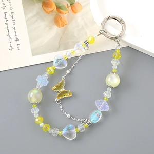Close-up of yellow butterfly heart beaded charm with silver spring clasp for bags
