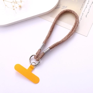 Close-up of sparkling rose gold rhinestone phone strap with silver ring and orange gasket