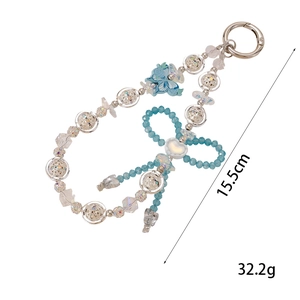Detail of beaded keychain with blue bow, silver metal spheres and crystal beads