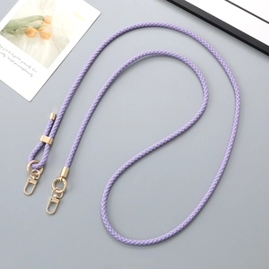 Detail view of woven purple leather cord with premium gold metal clasps for bags
