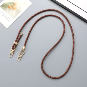 Close-up of brown braided leather strap with premium gold metal spring hook and ring