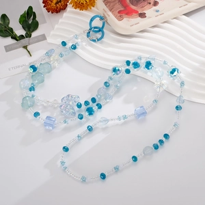Blue acrylic beaded phone strap with star and flower charms on white display