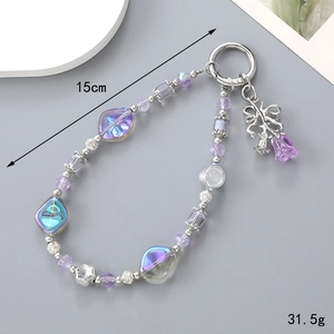 Crystal beaded keychain with purple flower charm and silver ring on a grey background