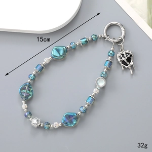 Detailed view of blue crystal beaded strap with silver accents and lava heart charm