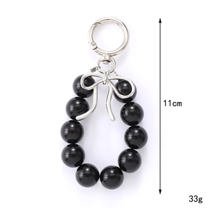 Silver bow charm with black UV beads for bags and phones, length 11cm and weight 33g