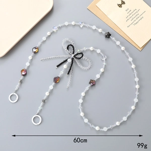 60cm beaded crossbody phone chain with crystal bow and white pearls on a tray