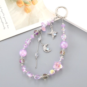 Detail of purple crystal beaded phone strap with silver moon and star charms