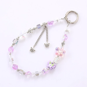 Dragonne en perles avec fleurs roses et violettes et pendentif papillon argenté