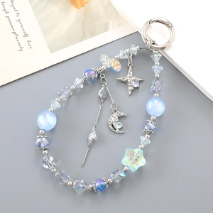 Detail of star and moon charms on a beaded strap with iridescent acrylic and blue glass beads