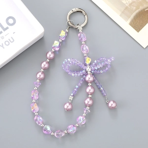 Macro detail of lavender beaded phone charm with crystal beads and woven bow decoration