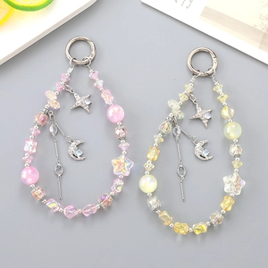 Pink and yellow beaded star charms with silver crescent moon pendants and metal rings