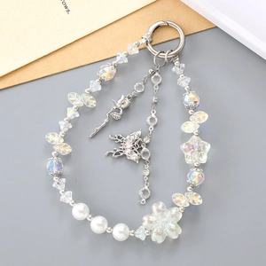 Exquisite pearl flower keychain with butterfly and tassel pendant on a grey backdrop