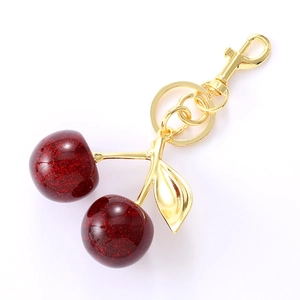 Elegant red crystal cherry keychain with gold leaf detail and glitter inside the cherry