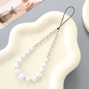 Elegant gradient pearl phone strap with crystal beads on a stylish cream tray