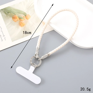 Close-up of cream woven PU leather phone lanyard with rhinestone metal ring and PVC patch