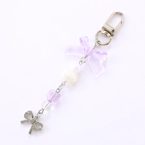 Chic pearl shell phone charm with purple bow and heart beads on a silver lobster clasp