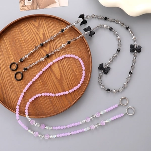 Detailed view of pink floral beaded phone straps with metallic clasps and resin charms
