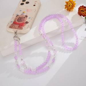 Detailed view of mobile phone case with bear motif and purple beaded crossbody lanyard