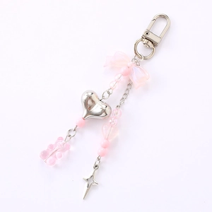 Pink bow keychain with candy color bear pendant and silver heart on white background