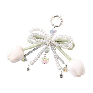 Green fabric tulip keychain with pearl bow and silver clasp on a white background